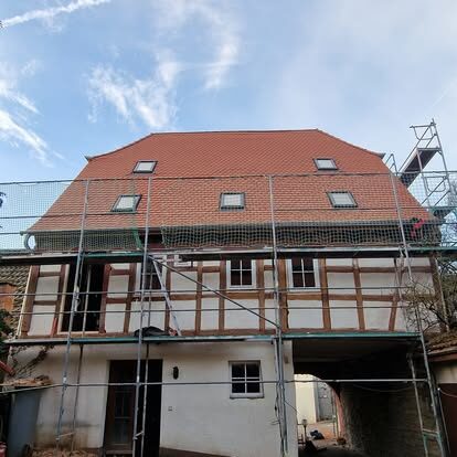 Mehrfamilienhaus mit rotem Ziegeldach und Fassade von vorne